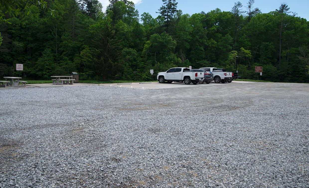 Image of a parking area next to a picnic area.