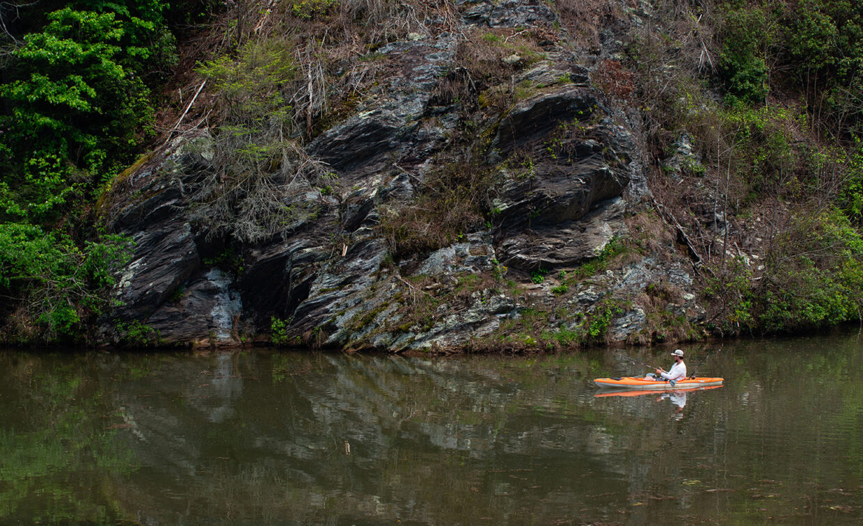 Image of a person on a lake kayaking.