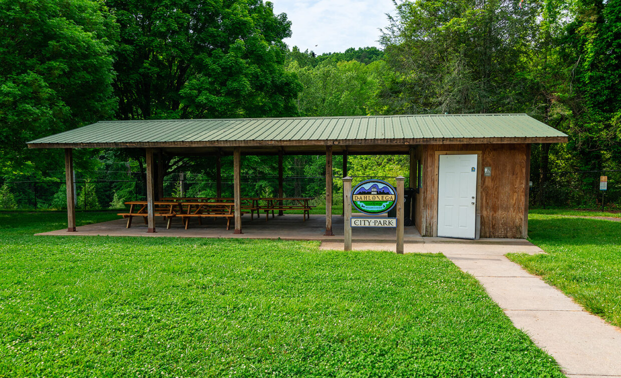 Dahlonega City Park sign with a shed in the background.